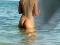 Sexy nudist girl enters the water