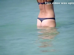 Hot milf enters the water to swim