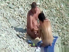 Nudist couple puts sun protection cream on their bodies