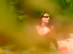 Horny girl masturbating on a beach