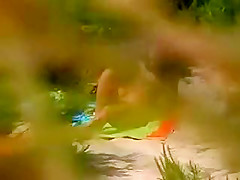 Horny girl masturbating on a beach