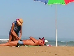 Hot lady gives a handjob at a beach