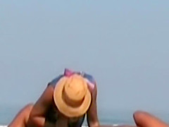 Hot lady gives a handjob at a beach
