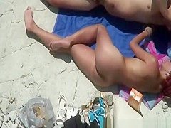 Fat nudist and his short redhead wife at beach