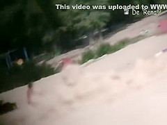 Voyeur at nudist beach films nude men and woman