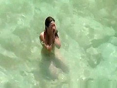 Nudist woman swimming in the fresh water