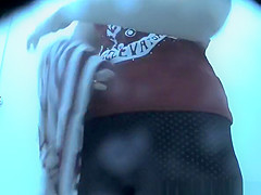 Woman in colorful dark bikini changes it