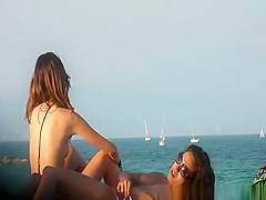 Topless lesbian brunettes at beach