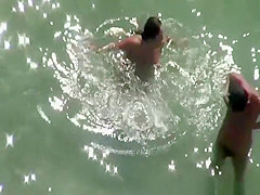 Chubby nudist woman sunbathing and swimming