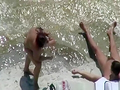 Chubby nudist woman sunbathing and swimming