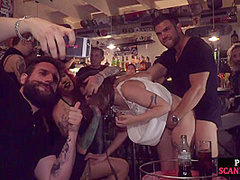 Gagged public slut sucks and cockrides in corwded bar