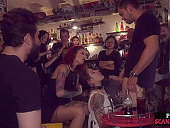 Gagged public slut sucks and cockrides in corwded bar