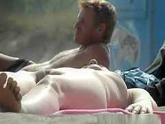 Nudist woman lying down in the sun sunbathing