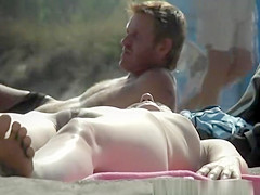 Nudist woman lying down in the sun sunbathing