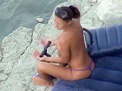 Hot girl pumping hard at the beach