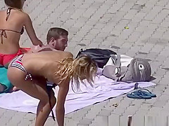 Blonde teen sunbathing by the pool