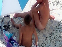 She yanks his dick while he lies down