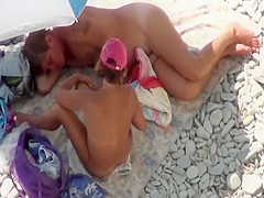 She yanks his dick while he lies down