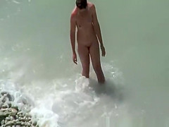 Small boobs nudist swimming in the water