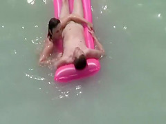 Small boobs nudist swimming in the water