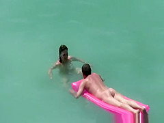 Small boobs nudist swimming in the water