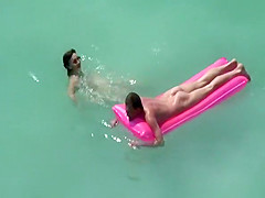 Small boobs nudist swimming in the water