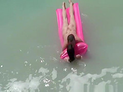 Small boobs nudist swimming in the water