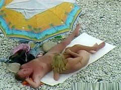 Nude couple enjoying beach day