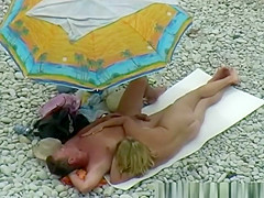 Nude couple enjoying beach day