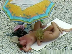 Nude couple enjoying beach day