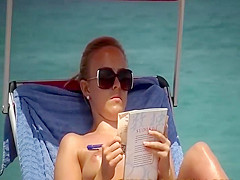 Spying a topless girl reading on a beach