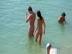 Brunette nudist woman with round tits in the beach