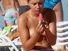Topless chick eats an ice cream