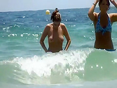 Beach babe spied while in topless