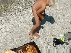 Mature nudist woman in the water