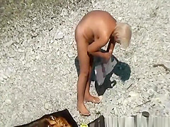 Mature nudist woman in the water