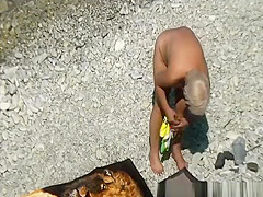 Mature nudist woman in the water