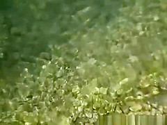 Mature nudist woman in the water