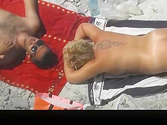 Chubby tattooed nudist woman sunbathing