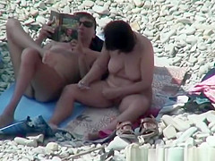 Busty nudist woman removing pubic hairs