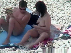 Busty nudist woman removing pubic hairs