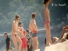 Nudist couple by the water