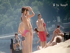 Nudist couple by the water