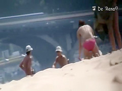 Nudist couple by the water