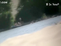 Nudist couple by the water