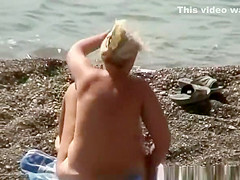 Mature nudist woman swimming