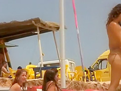 Hot girl undresses herself on a beach