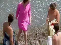 Group of nudist women in the beach