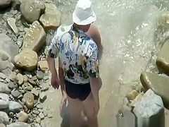 Naked woman in rocky beach