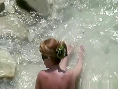 Naked woman in rocky beach